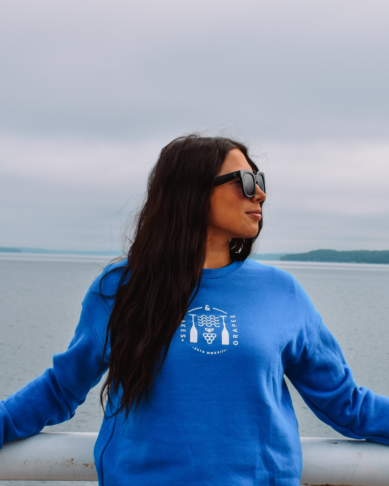 The image shows a Lifestyle Crew Sweatshirt in a deep royal blue color. The sweatshirt appears soft and comfortable, made from a cozy fabric.