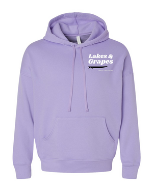 In this image, we see a Lakes and Grapes Great Lakes Surf Hoodie. This sweatshirt, available in a cool dark lavender color, captures the spirit of the water like no other.