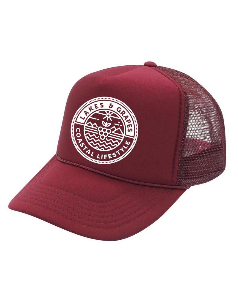 This image depicts the Lakes and Grapes Maroon Coastal Lifestyle Trucker Hat. The hat is a classic trucker style with a structured front panel and a gently curved brim. It's a versatile and fashionable accessory suitable for outdoor activities and coastal enthusiasts.