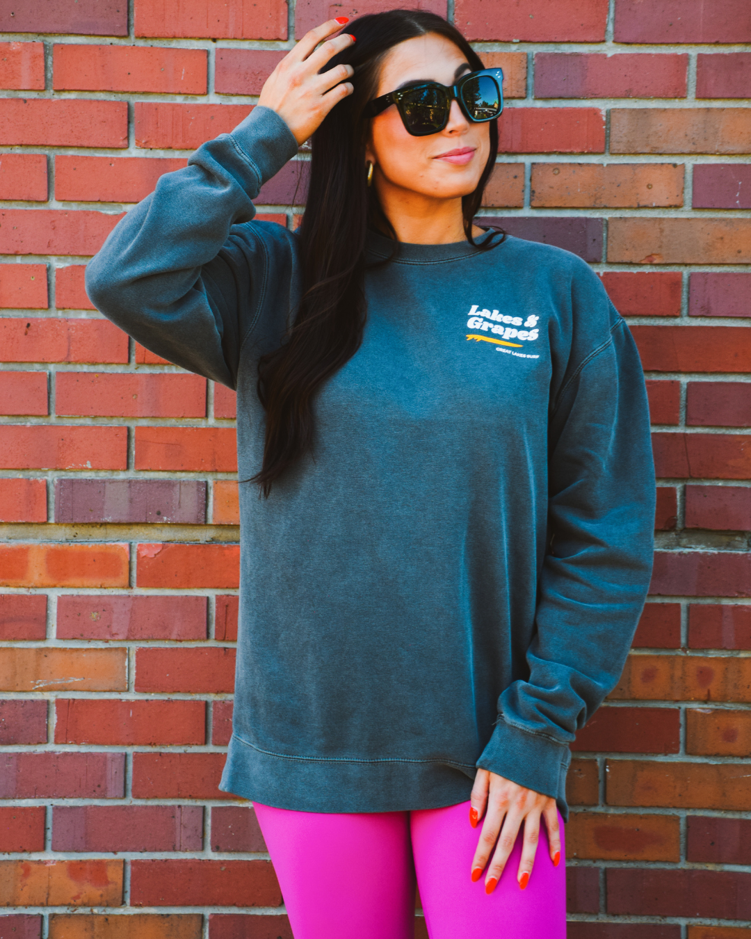 In this image, we see a Lakes and Grapes Great Lakes Surf Crew Sweatshirt. It features a classic crewneck design with long sleeves, ideal for cooler weather or casual wear.