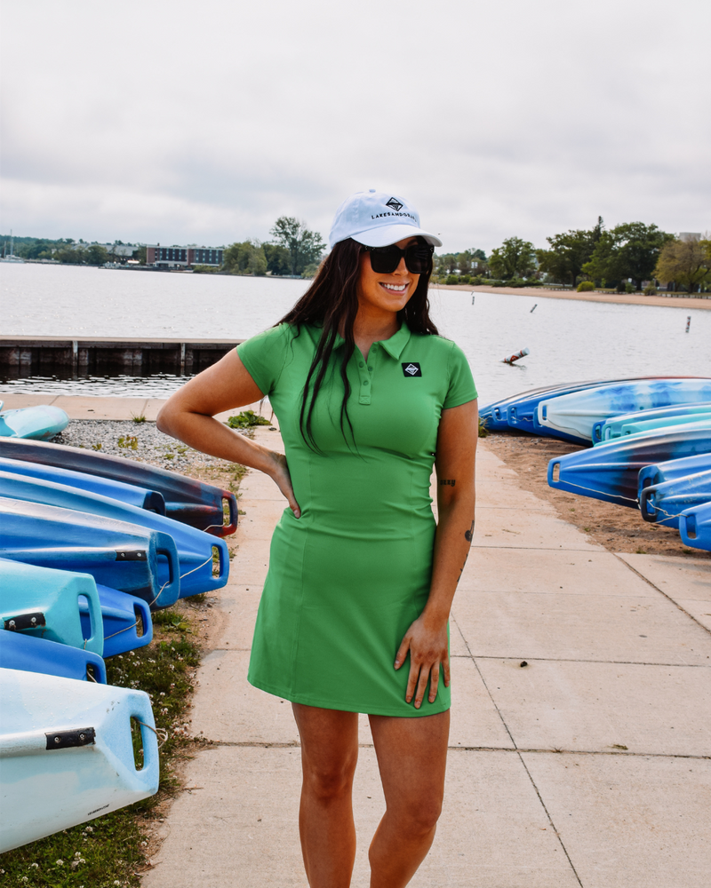 This image showcases the Lakes and Grapes Green Active Golf Dress. It features a comfortable and flexible fit, perfect for a day on the golf course or out on the town.