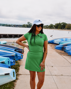 This image showcases the Lakes and Grapes Green Active Golf Dress. It features a comfortable and flexible fit, perfect for a day on the golf course or out on the town.