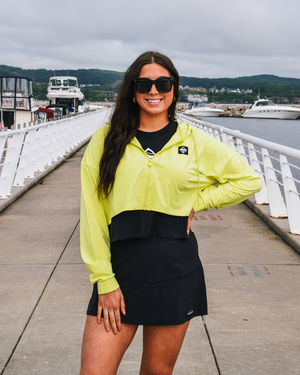 This image displays the Lakes and Grapes Black Active Swoop Tennis Skort. The skort combines the comfort of shorts with the elegance of a skirt, making it an excellent choice for tennis and other active pursuits.