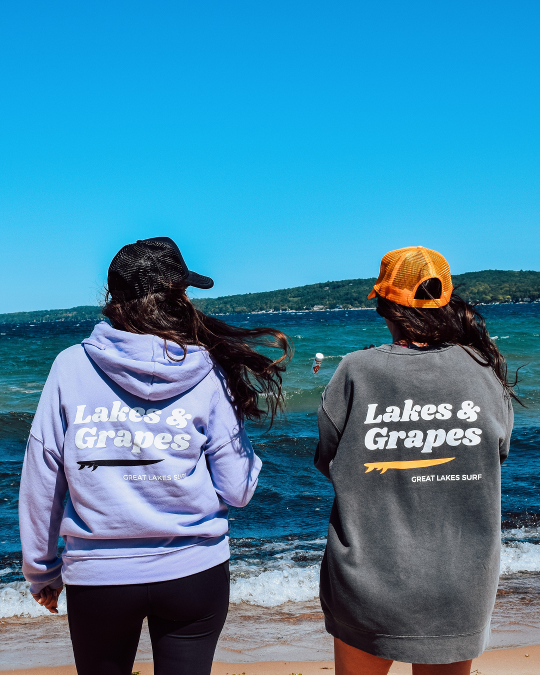 In this image, we see a Lakes and Grapes Great Lakes Surf Trucker Hat. Experience comfort and style as you embrace the spirit of the Great Lakes.