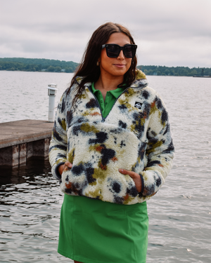 This image showcases the Lakes and Grapes Green Active Golf Dress paired with a Tie Dye Sherpa Pullover. It features a comfortable and flexible fit, perfect for a day on the golf course or out on the town.