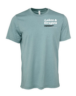 This image features a Lakes and Grapes Great Lakes Surf Tee. Crafted for those who can't get enough of the water, this tee captures that lake-life spirit effortlessly.