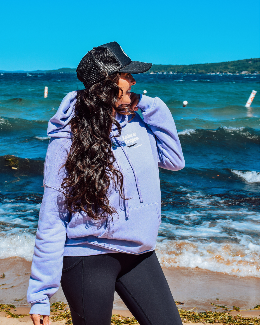 This image depicts the Lakes and Grapes Coastal Lifestyle Trucker Hat. The hat is a classic trucker style with a structured front panel and a gently curved brim. It's a versatile and fashionable accessory suitable for outdoor activities and coastal enthusiasts.