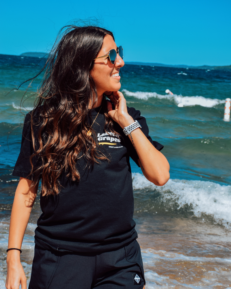 
            
                Load image into Gallery viewer, This image features a Lakes and Grapes Great Lakes Surf Tee. Crafted for those who can&amp;#39;t get enough of the water, this tee captures that lake-life spirit effortlessly.
            
        
