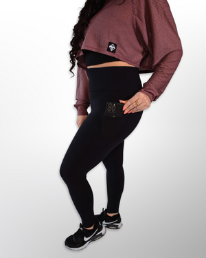 This image displays the Lakes and Grapes Active Mesh Crop Long Sleeve (LS). The crop top is designed for active wear, combining style and functionality. It features mesh panels for breathability and a flattering fit.