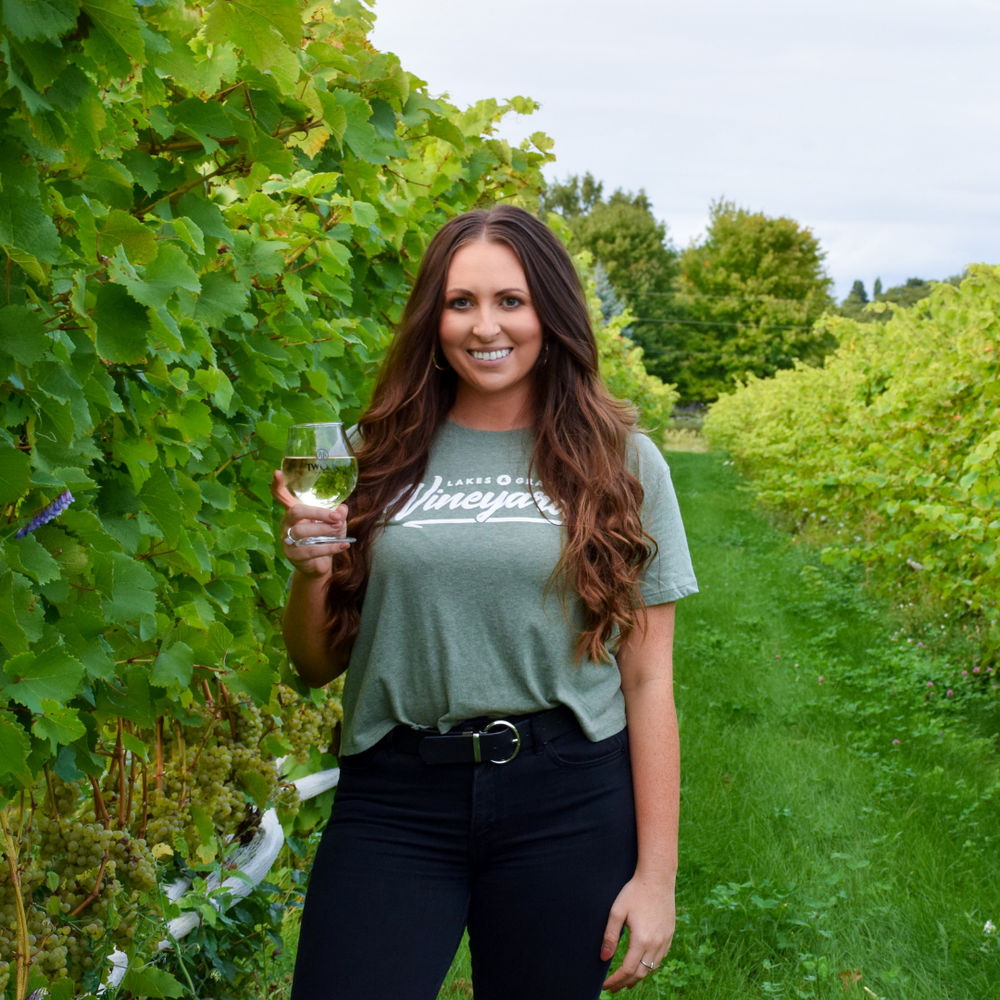 
            
                Load image into Gallery viewer, Wine Tasting in a Northern Michigan Vineyard wearing the Lakes and Grapes Women&amp;#39;s Vineyard Crop Tee
            
        