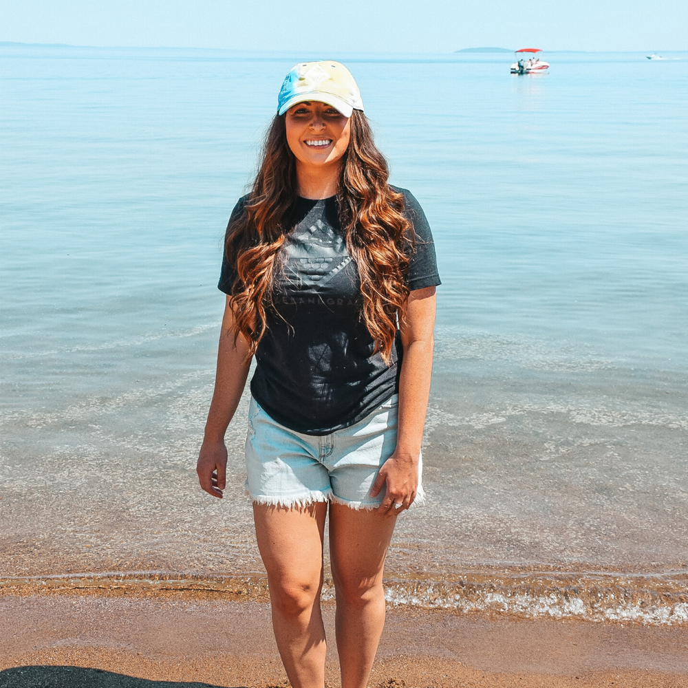 
            
                Load image into Gallery viewer, Walking the sandy beaches in Northern Michigan wearing a Lakes and Grapes Tie Dye Hat
            
        