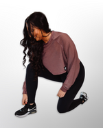 This image displays the Lakes and Grapes Active Mesh Crop Long Sleeve (LS). The crop top is designed for active wear, combining style and functionality. It features mesh panels for breathability and a flattering fit.